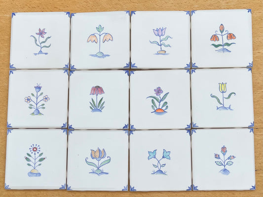 Set of twelve 4.25" hand painted tiles, polychromatic Delft style