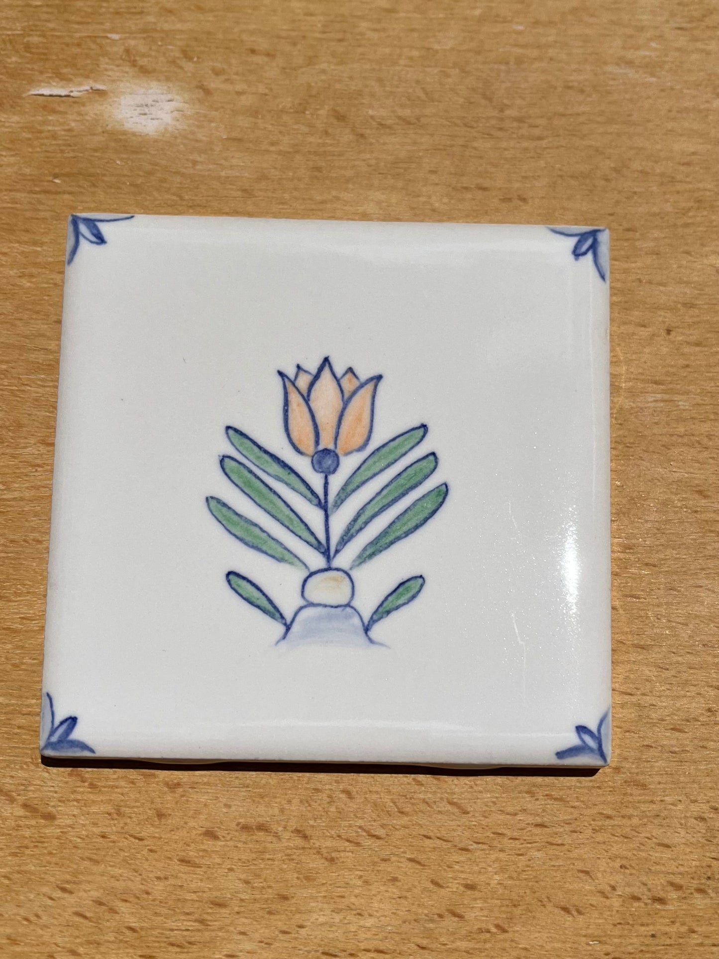 Nine hand painted 4.25" tiles, polychromatic Delft style