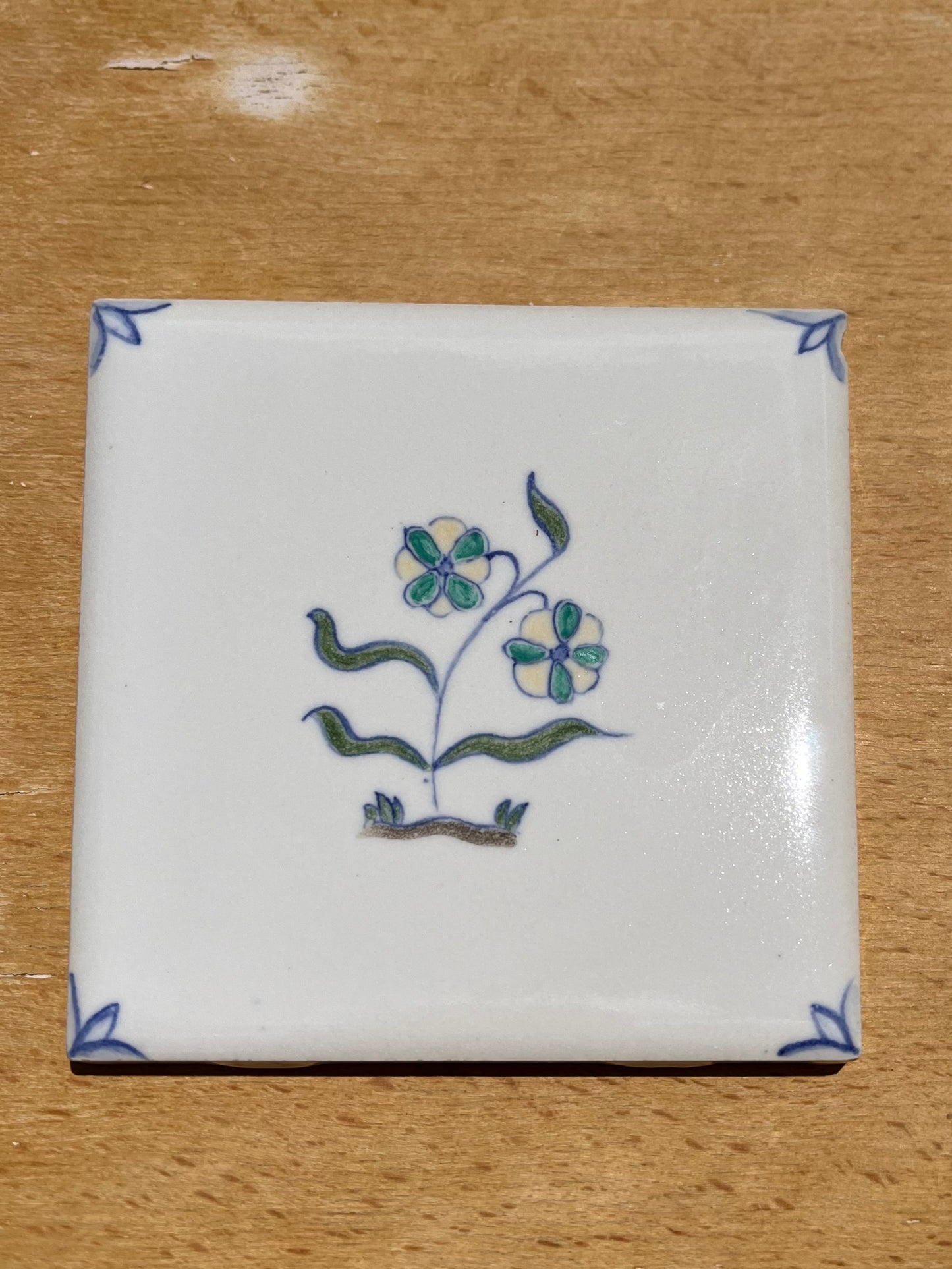 Nine hand painted 4.25" tiles, polychromatic Delft style